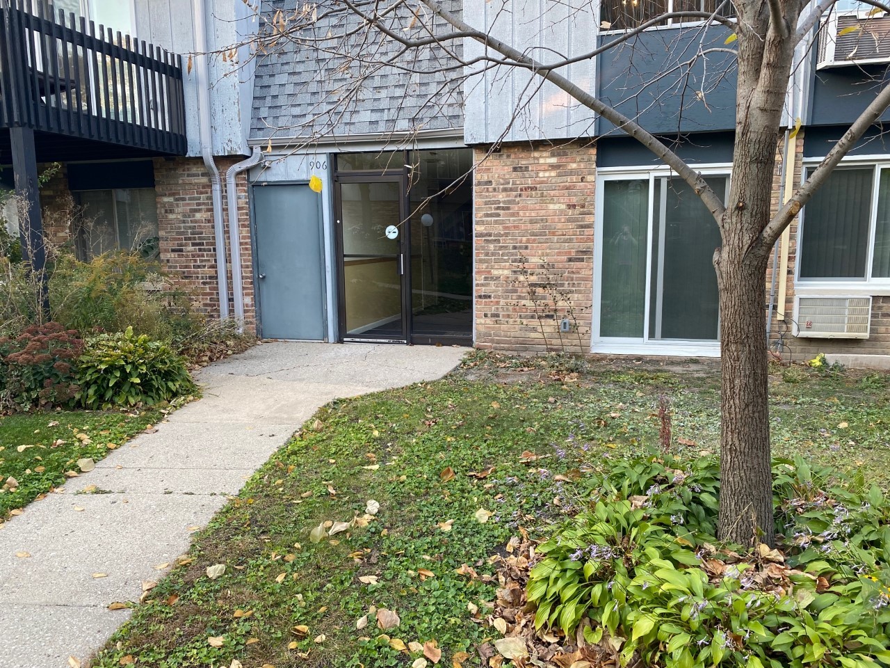 906 East Old Willow Road, Unit 104 Prospect Heights, IL 60070 - Photo 2 of 20 a view of a house with brick walls and a yard