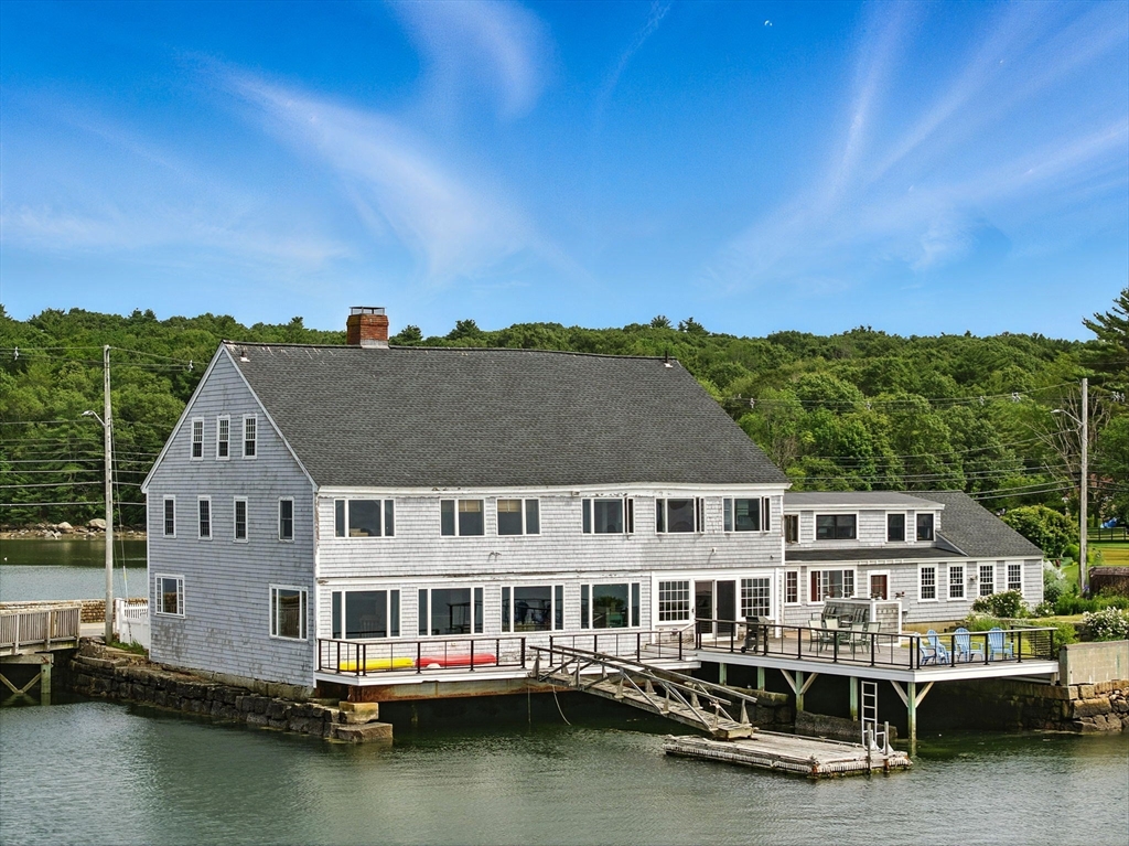 an aerial view of residential houses with outdoor space and swimming pool