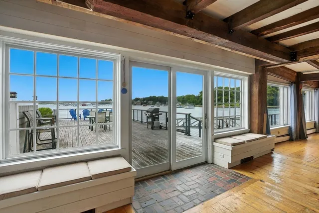 a living room with furniture and large windows