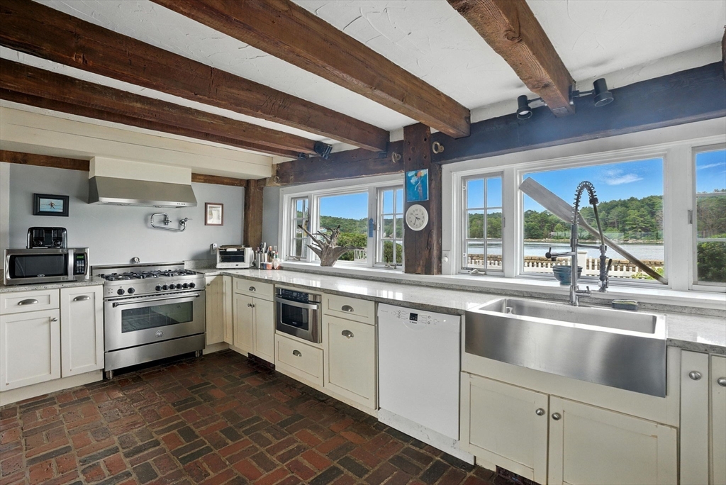672 Washington Street Gloucester, MA 01930 - Photo 15 of 27 a kitchen with sink stove and cabinets