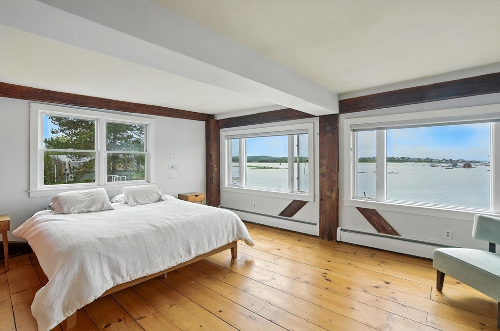 672 Washington Street Gloucester, MA 01930 - Photo 17 of 27 a bedroom with a bed and large window