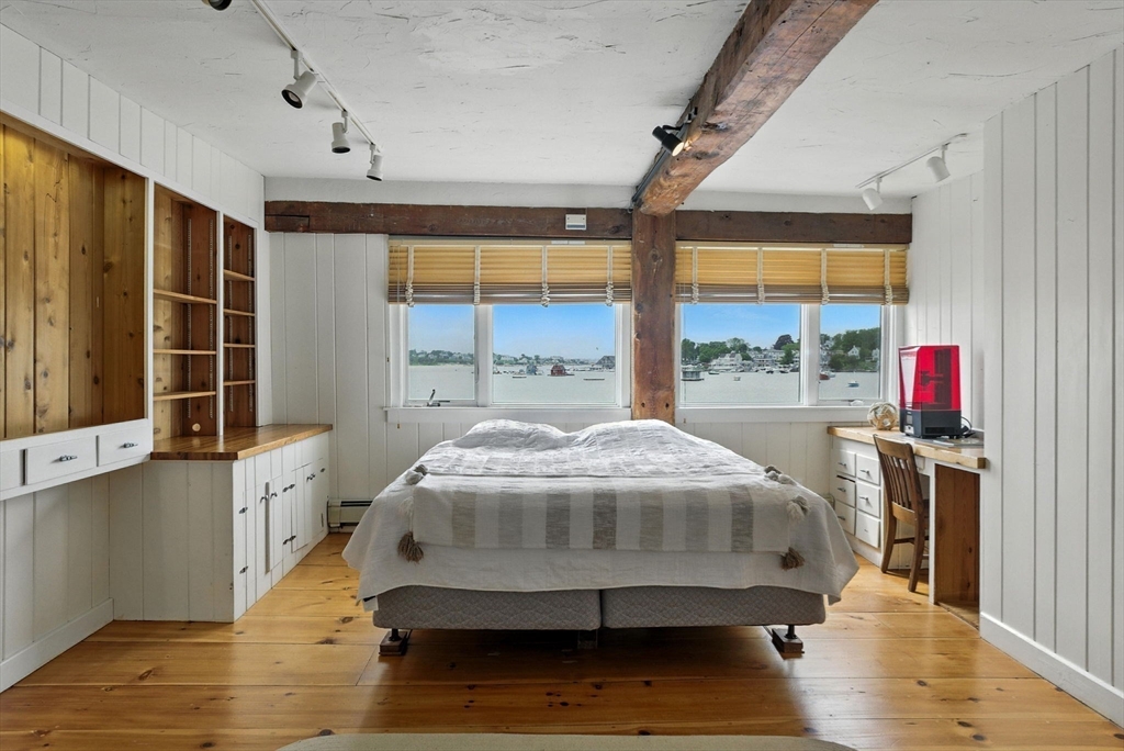 672 Washington Street Gloucester, MA 01930 - Photo 19 of 27 a spacious bedroom with a large bed and a large window
