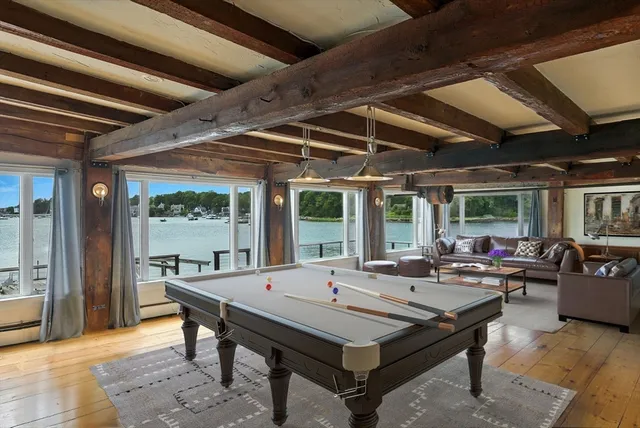 a living room with furniture a table and large windows