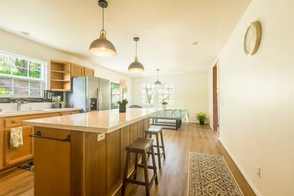 a kitchen with stainless steel appliances granite countertop a sink and a stove