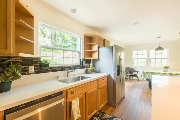 a kitchen with stainless steel appliances granite countertop a sink and cabinets