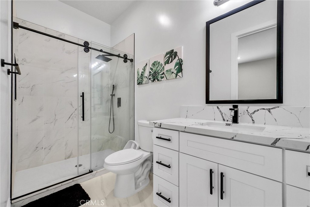 451 Avenida Esplendor Walnut, CA 91789 - Photo 32 of 51 a bathroom with a shower sink vanity mirror and toilet