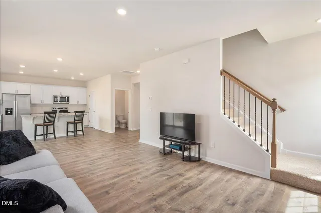 a view of a livingroom with furniture and a flat screen tv