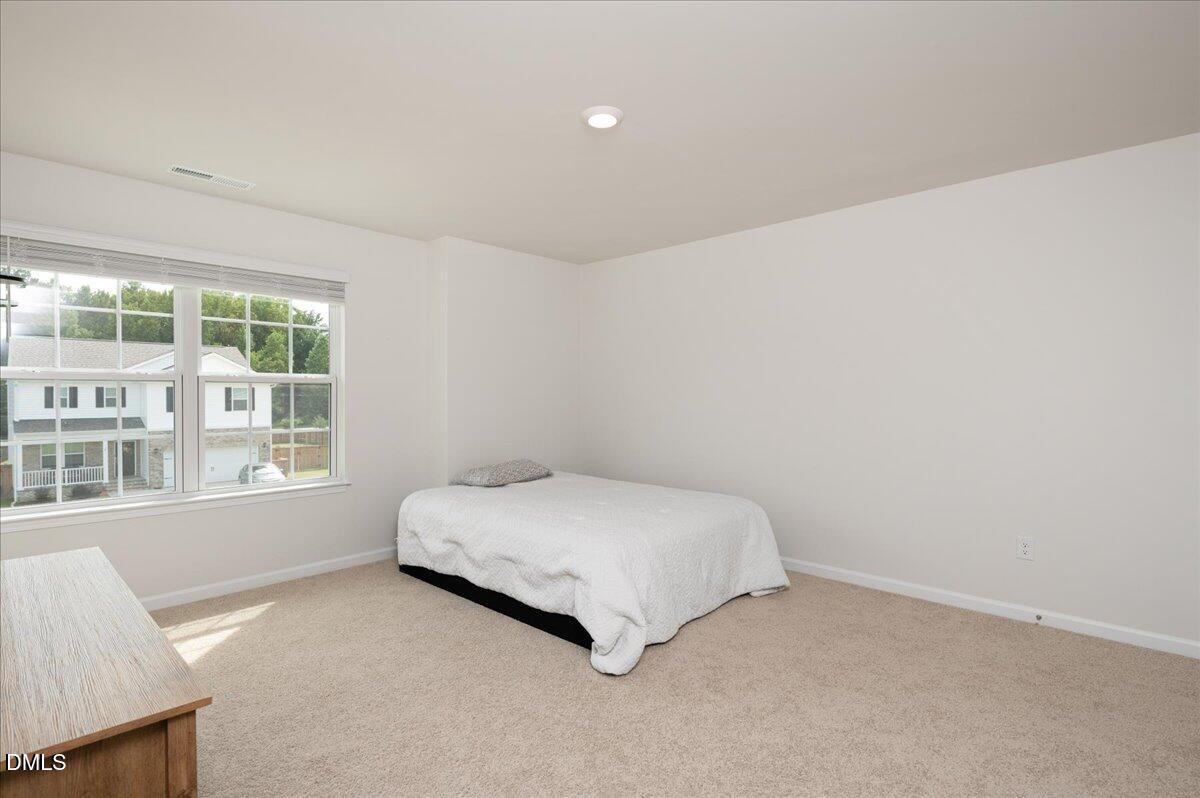 10 Whispering Willow Circle Youngsville, NC 27596 - Photo 18 of 28 a spacious bedroom with a bed and a window