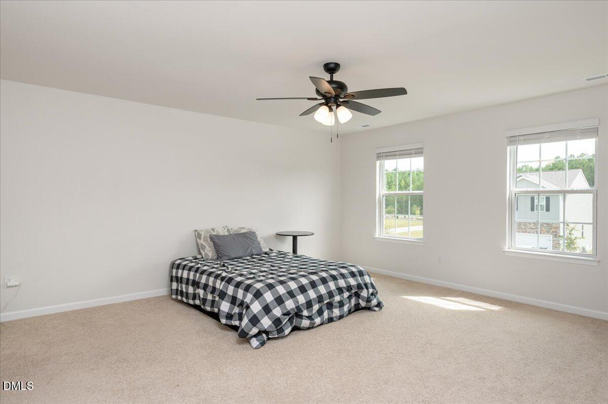 10 Whispering Willow Circle Youngsville, NC 27596 - Photo 19 of 28 a bedroom with a bed furniture and a window