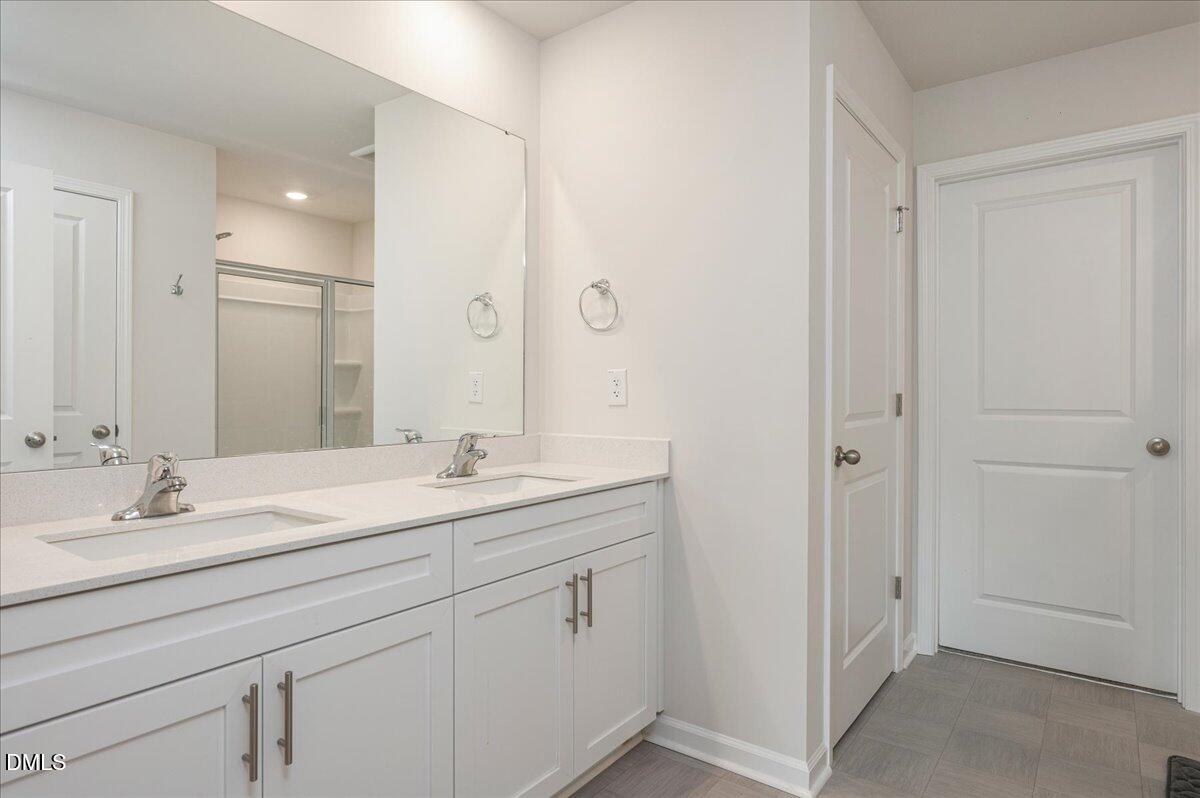 10 Whispering Willow Circle Youngsville, NC 27596 - Photo 20 of 28 a bathroom with a sink and a mirror