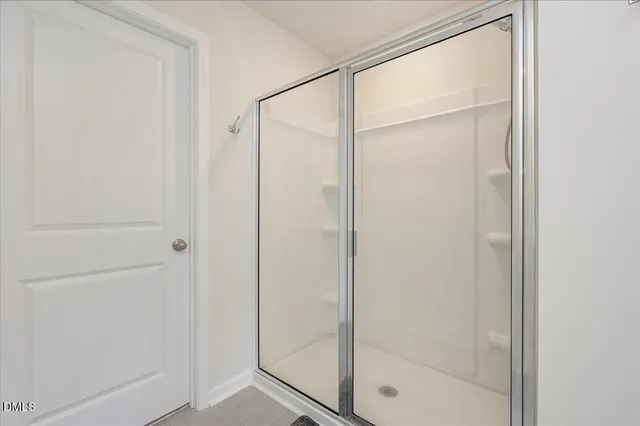 a bathroom with a glass shower door