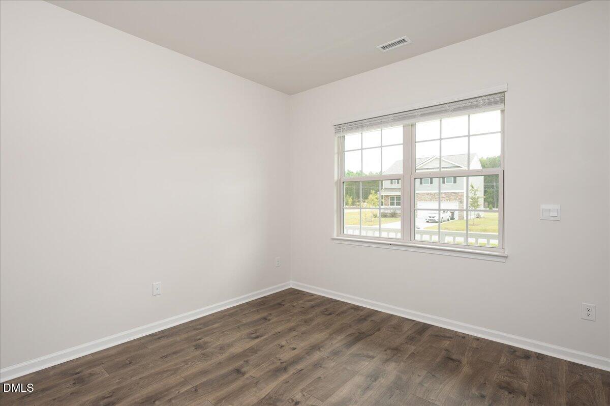 10 Whispering Willow Circle Youngsville, NC 27596 - Photo 5 of 28 an empty room with wooden floor and windows