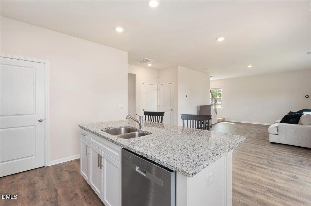 10 Whispering Willow Circle Youngsville, NC 27596 - Photo 8 of 28 a kitchen with stainless steel appliances granite countertop a sink and a refrigerator