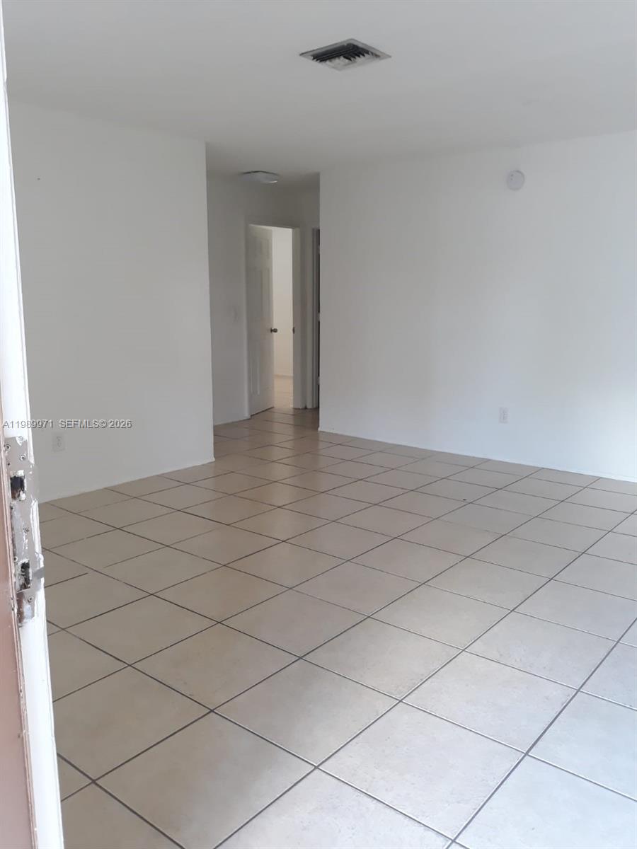 4380 Lakewood Road, Unit 4380 Lake Worth, FL 33461 - Photo 12 of 17 a view of an empty room and wooden floor