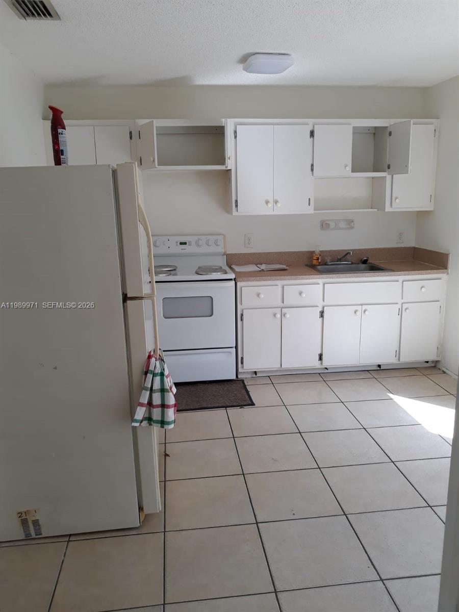 4380 Lakewood Road, Unit 4380 Lake Worth, FL 33461 - Photo 14 of 17 a kitchen with a cabinets and appliances
