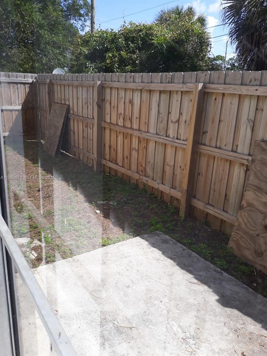 4380 Lakewood Road, Unit 4380 Lake Worth, FL 33461 - Photo 3 of 17 a view of a backyard with wooden fence