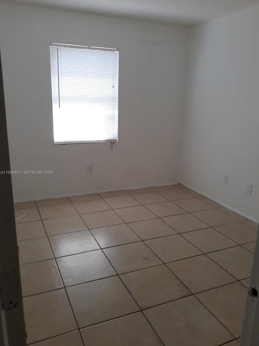 4380 Lakewood Road, Unit 4380 Lake Worth, FL 33461 - Photo 6 of 17 an empty room with a window