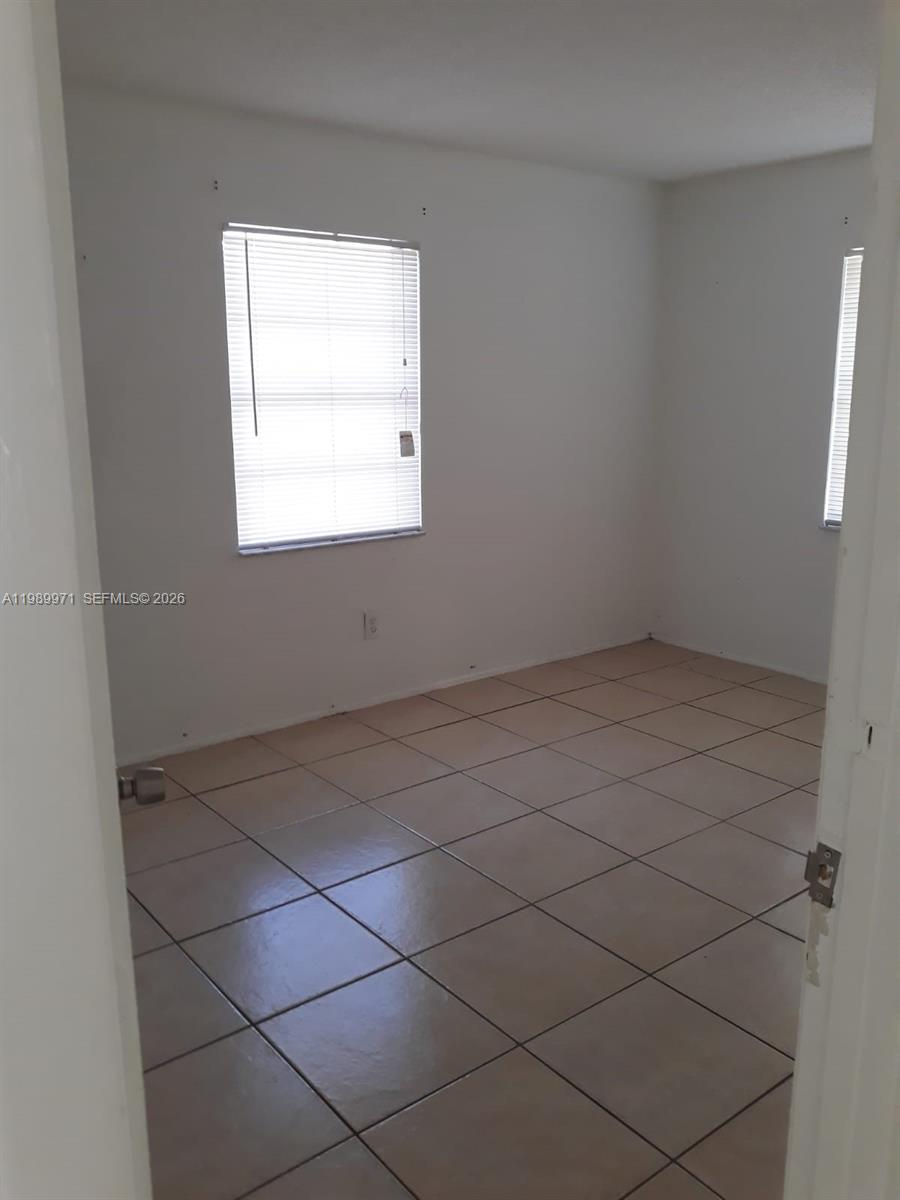4380 Lakewood Road, Unit 4380 Lake Worth, FL 33461 - Photo 8 of 17 an empty room with a window