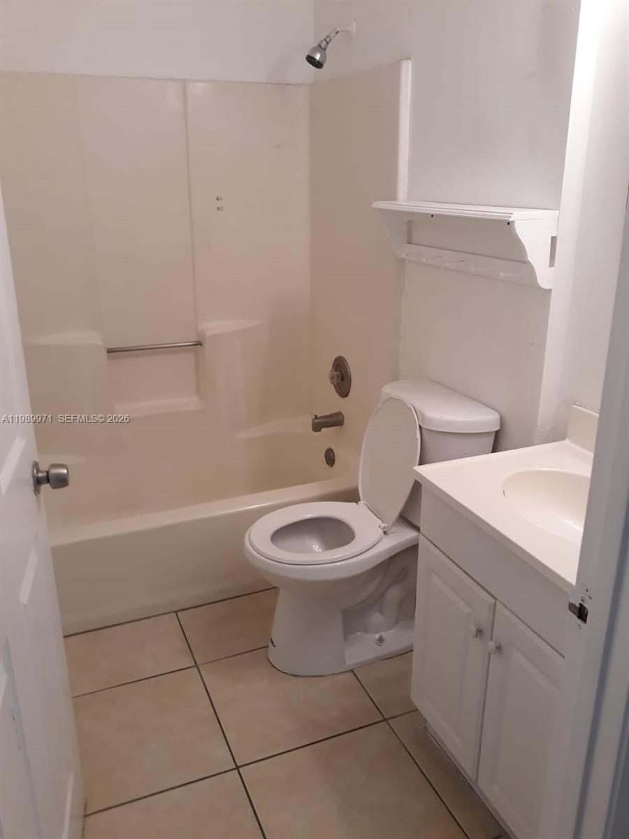 4380 Lakewood Road, Unit 4380 Lake Worth, FL 33461 - Photo 10 of 17 a white toilet sitting next to a bath tub