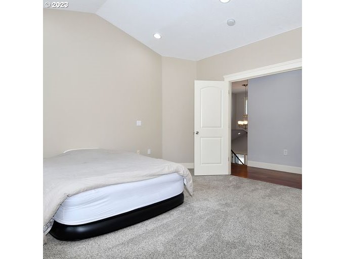 12614 Southeast Tibbetts Street Portland, OR 97236 - Photo 11 of 31 a bedroom with a bed and a cabinets