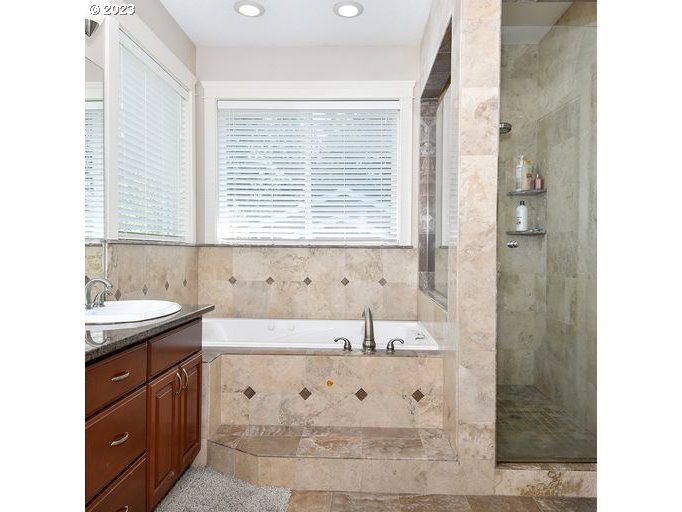 12614 Southeast Tibbetts Street Portland, OR 97236 - Photo 13 of 31 a bathroom with a sink vanity tub and shower
