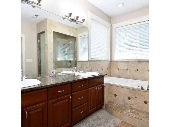 12614 Southeast Tibbetts Street Portland, OR 97236 - Photo 14 of 31 a bathroom with a granite countertop bathtub sink double and mirror