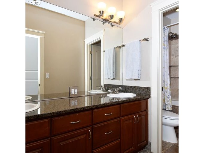12614 Southeast Tibbetts Street Portland, OR 97236 - Photo 20 of 31 a bathroom with a double vanity sink and a mirror