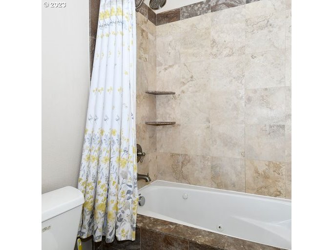 12614 Southeast Tibbetts Street Portland, OR 97236 - Photo 21 of 31 a bathroom with a bathtub and shower