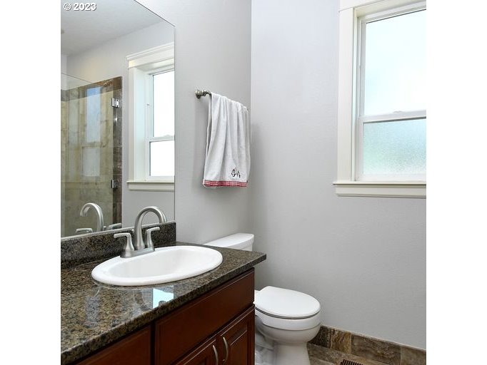 12614 Southeast Tibbetts Street Portland, OR 97236 - Photo 24 of 31 a bathroom with a toilet sink and mirror