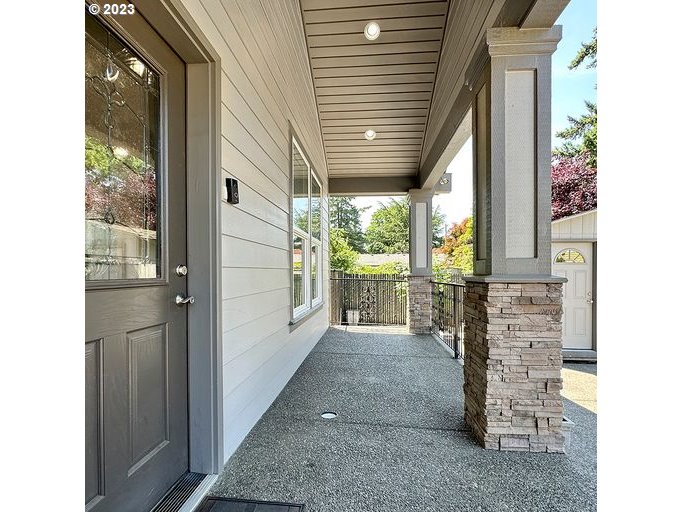 12614 Southeast Tibbetts Street Portland, OR 97236 - Photo 5 of 31 a view of a porch with a table and chairs