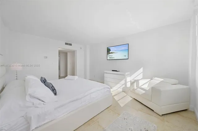 a bedroom with a bed and a painting on the wall