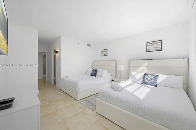 a bedroom with two beds and white doors