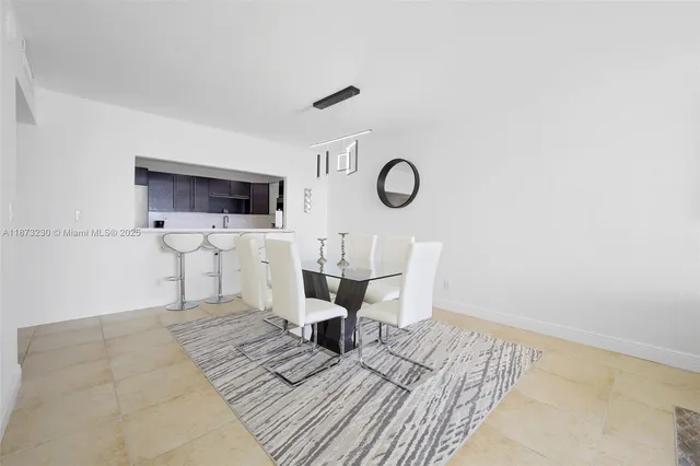 a living room with furniture a clock and white walls