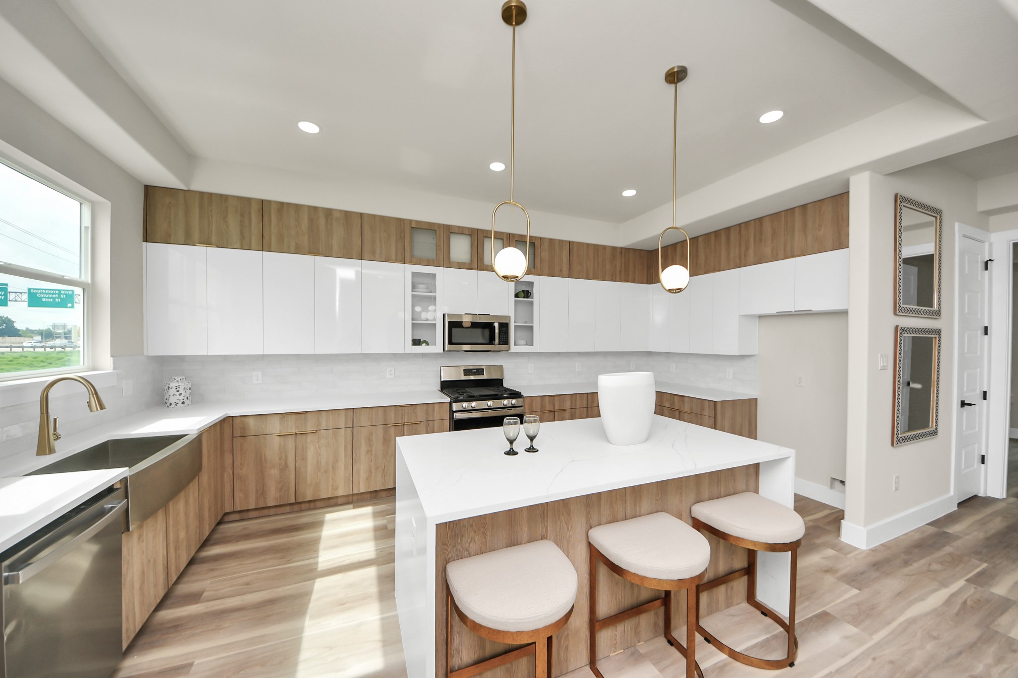 2014 Blodgett Street Houston, TX 77004 - Photo 13 of 49 a kitchen with a dining table chairs sink and white cabinets