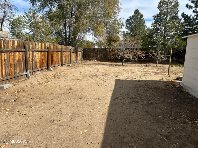 a view of yard with wooden fence