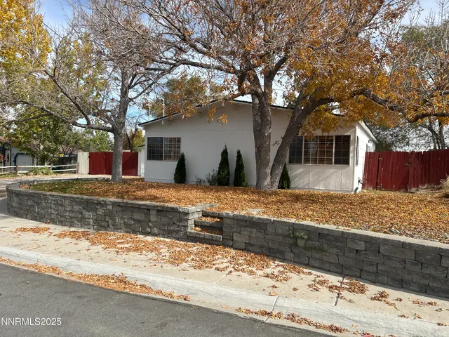 a view of a house with snow on the side of the road