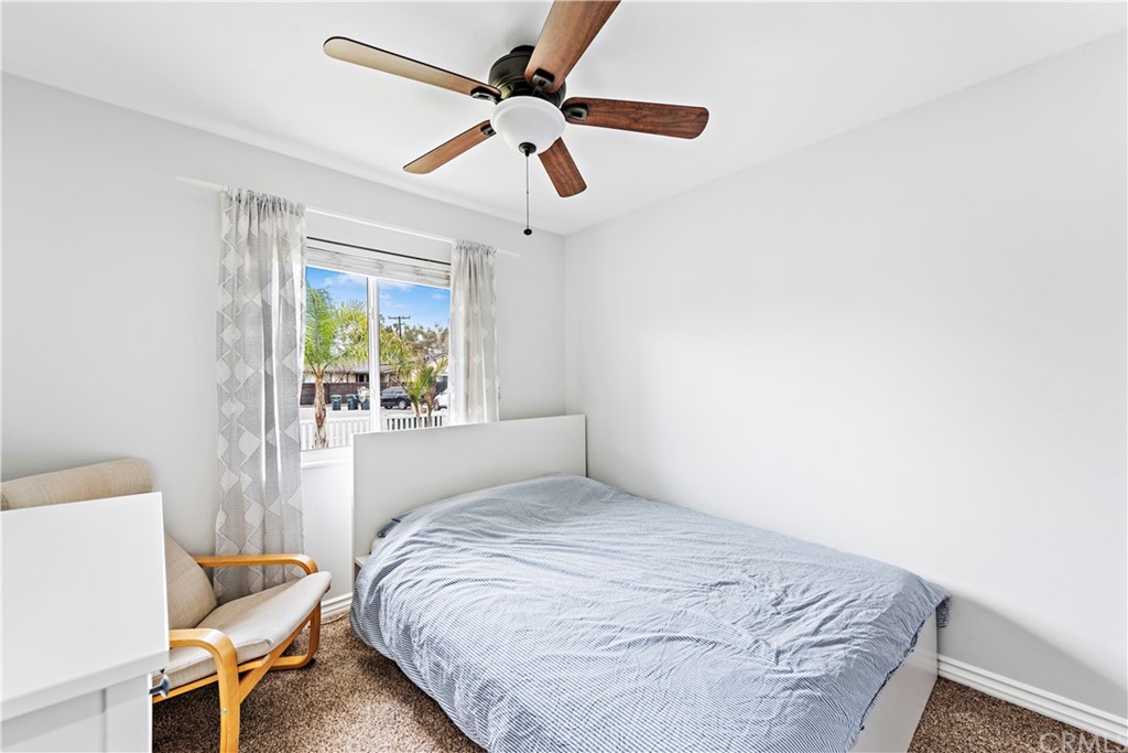 3040 Harding Way Costa Mesa, CA 92626 - Photo 11 of 17 a bedroom with a bed and a chandelier