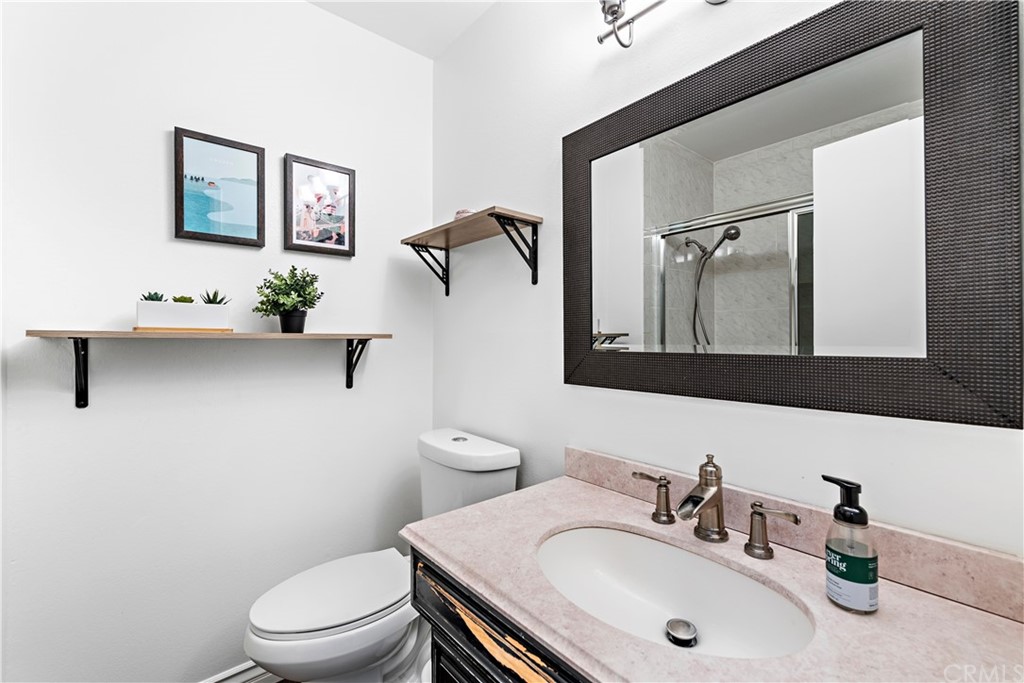 3040 Harding Way Costa Mesa, CA 92626 - Photo 13 of 17 a bathroom with a sink a toilet and mirror