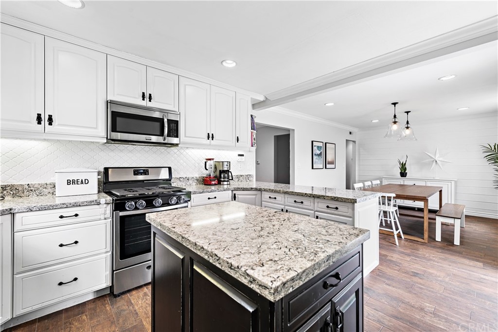 3040 Harding Way Costa Mesa, CA 92626 - Photo 8 of 17 a kitchen with stainless steel appliances granite countertop a stove oven and a white cabinets