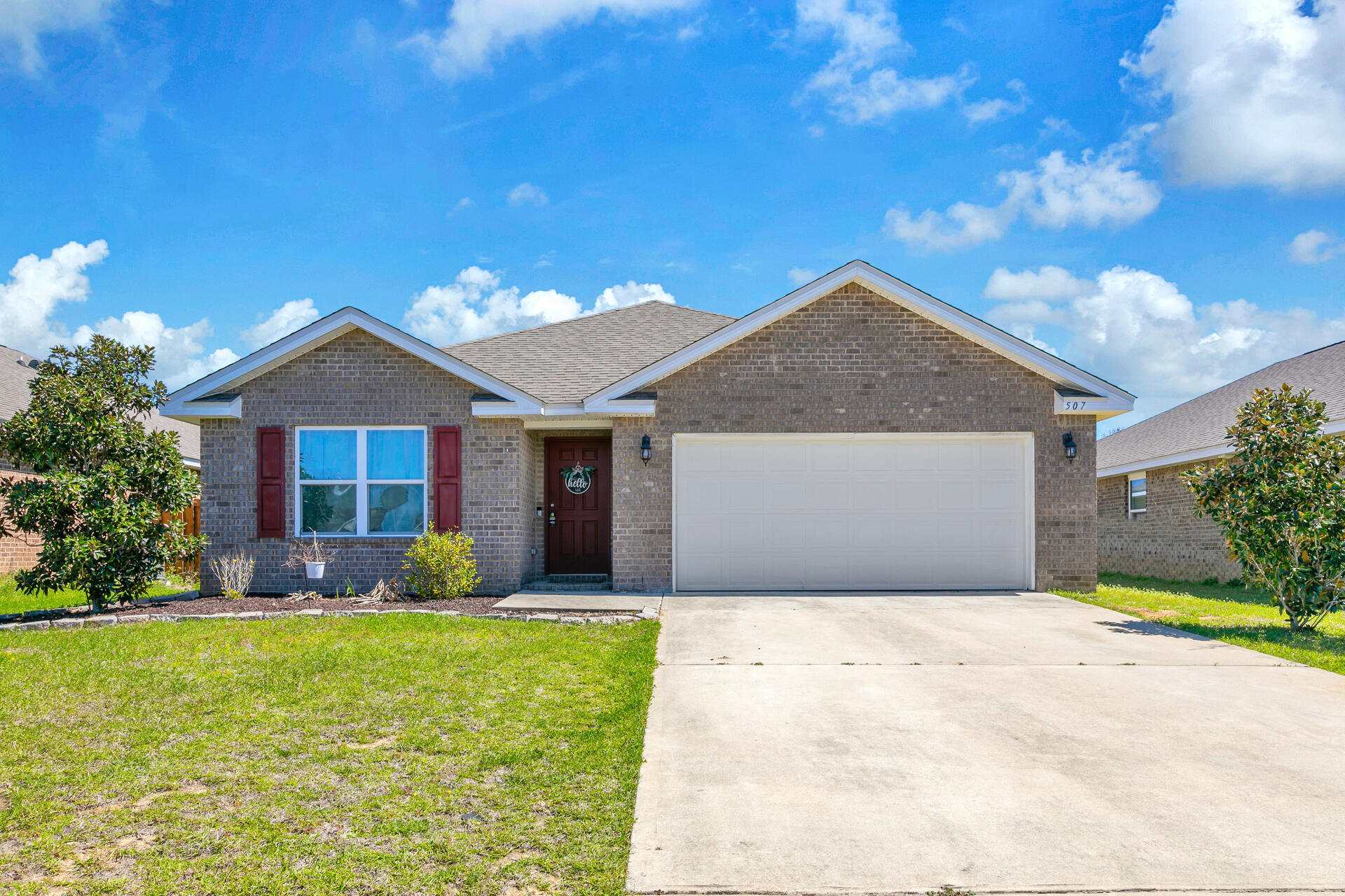 a front view of house with yard and green space