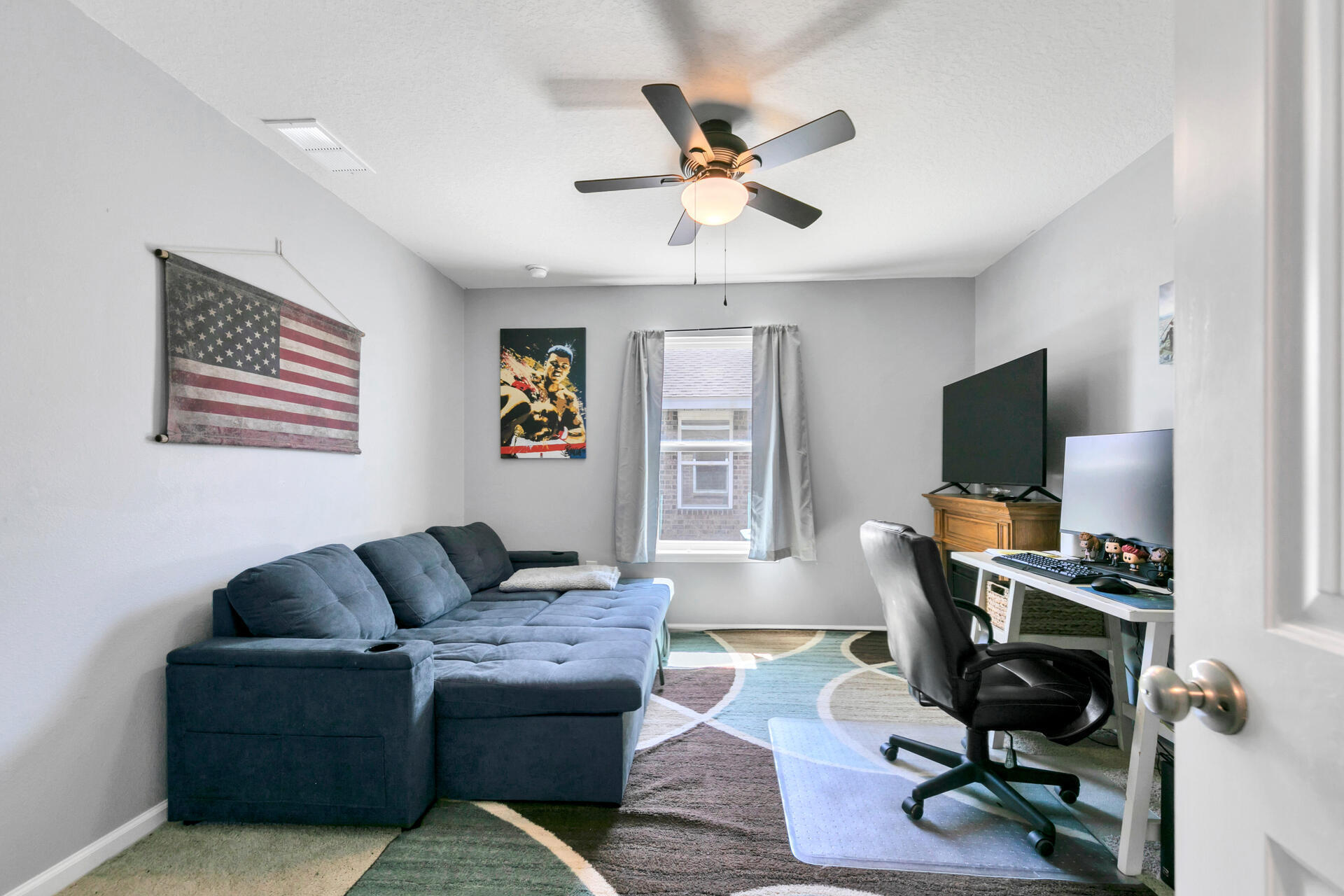 507 Merganser Way Crestview, FL 32539 - Photo 13 of 45 a living room with furniture a flat screen tv and a window