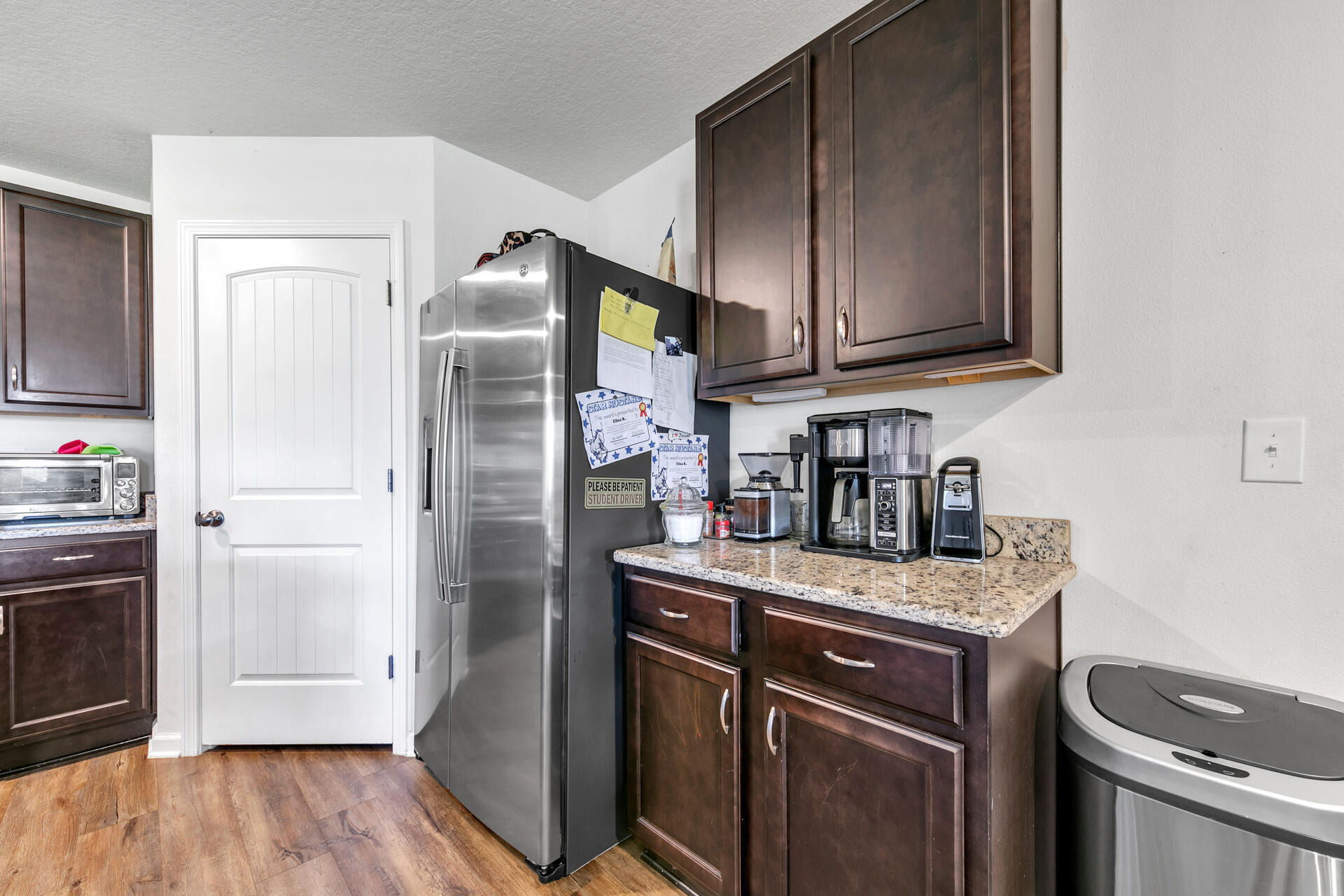 507 Merganser Way Crestview, FL 32539 - Photo 20 of 45 a kitchen with stainless steel appliances granite countertop a refrigerator a stove and a sink with wooden cabinets
