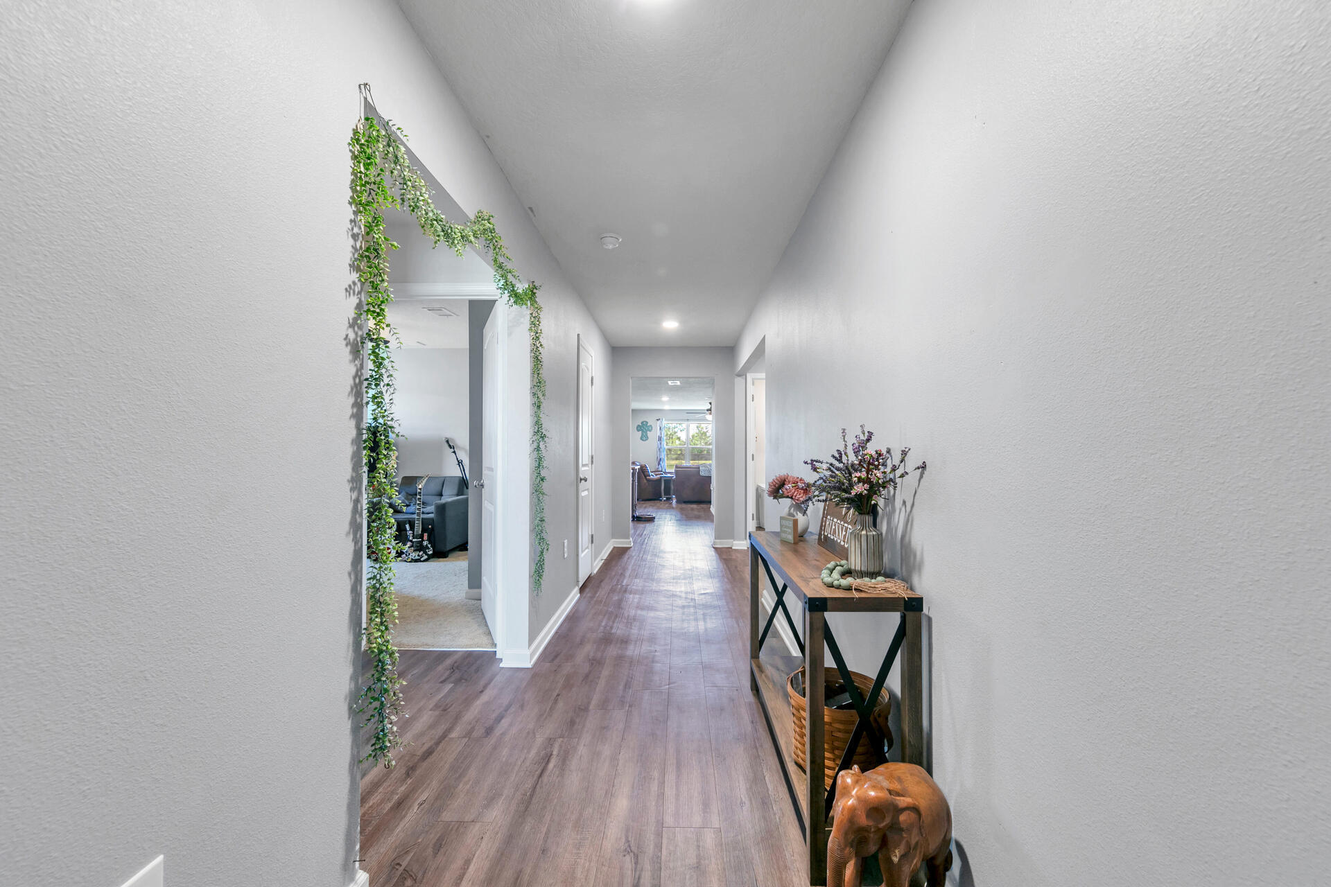 507 Merganser Way Crestview, FL 32539 - Photo 3 of 45 a view of a hallway with wooden floor and a potted plant