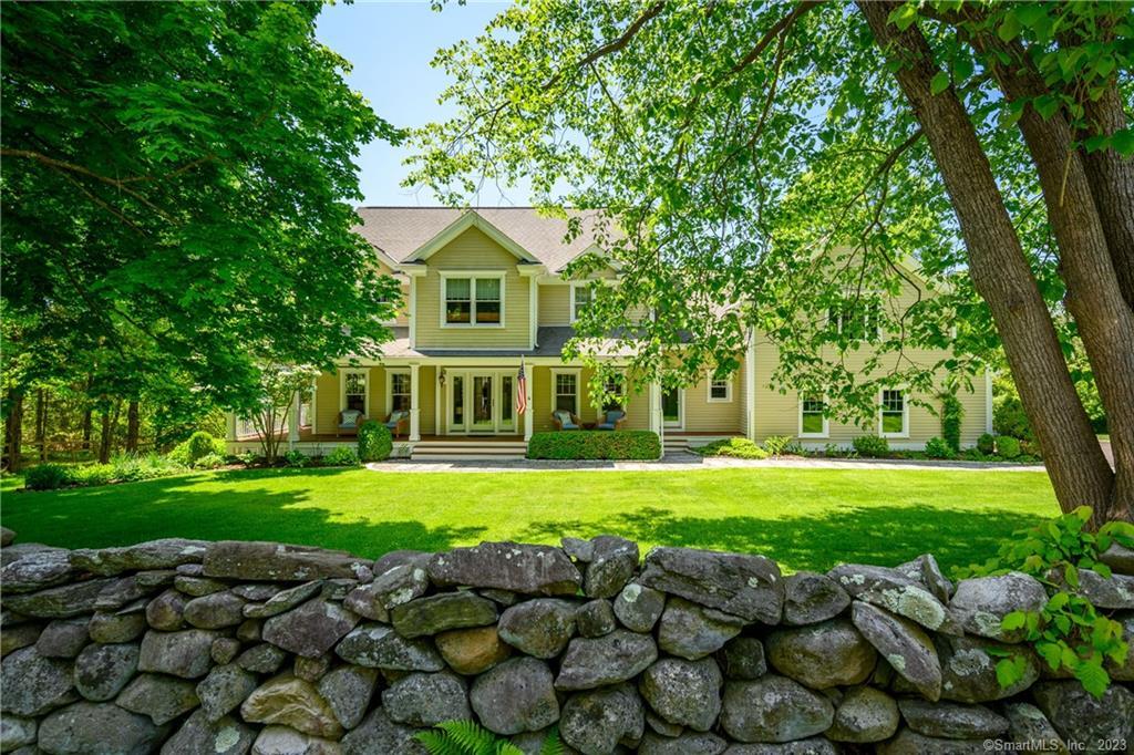 A sprawling manicured lawn framed by an ancient stone wall...........