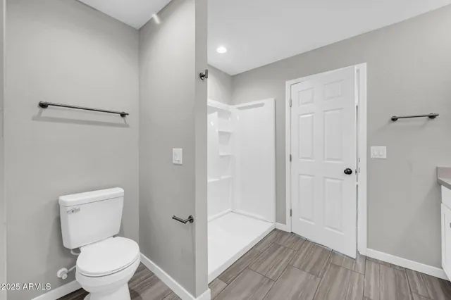 a bathroom with a toilet a sink and shower