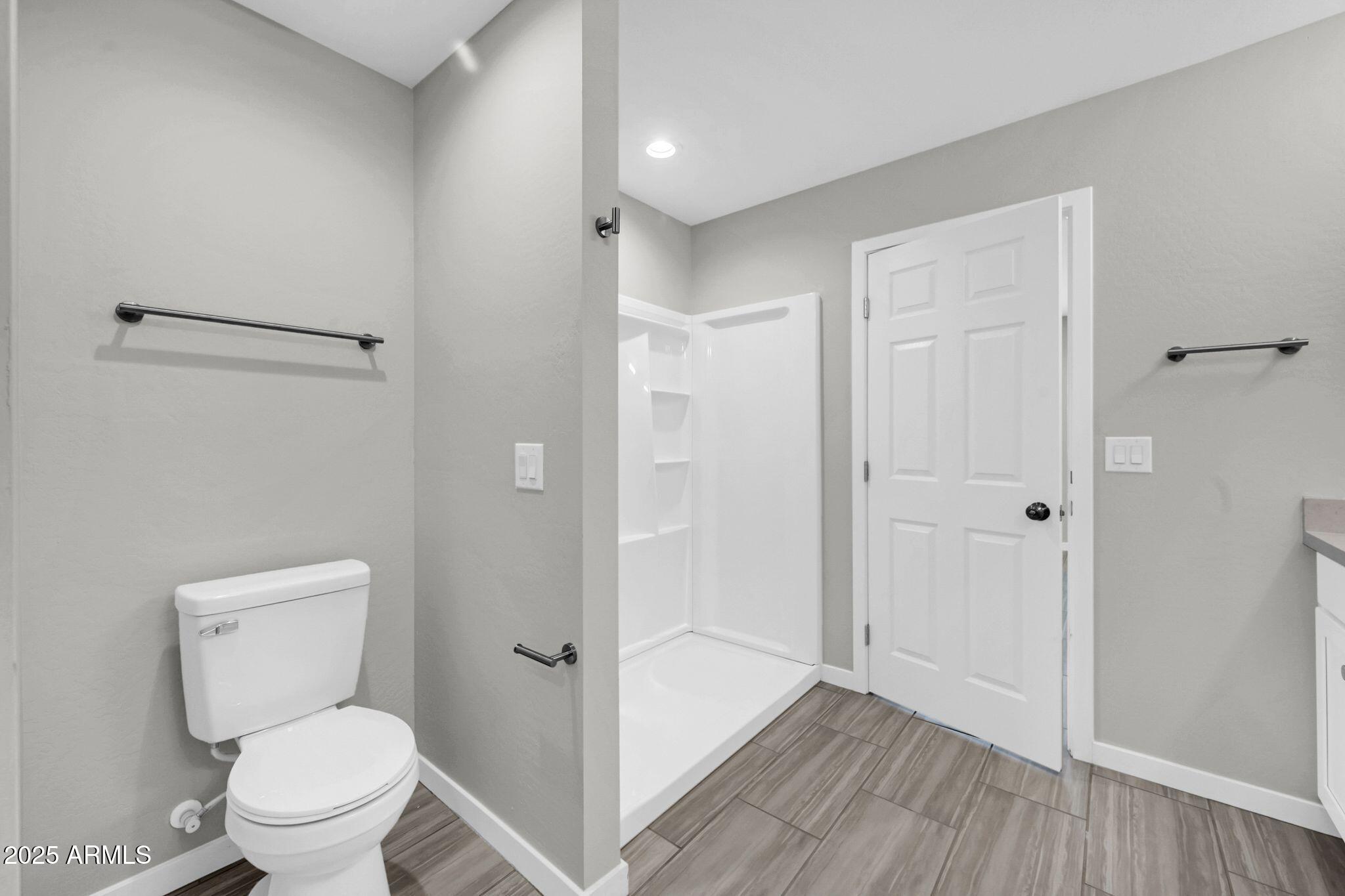 13215 South Laredo Road Arizona City, AZ 85123 - Photo 13 of 31 a bathroom with a toilet a sink and shower