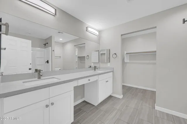a spacious bathroom with a granite countertop sink mirror and double