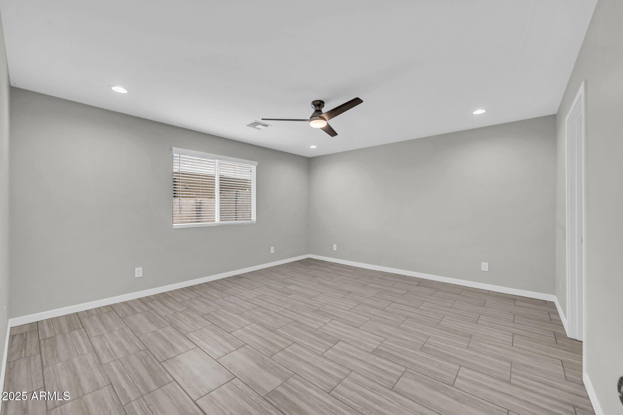 13215 South Laredo Road Arizona City, AZ 85123 - Photo 17 of 31 wooden floor in an empty room with a window