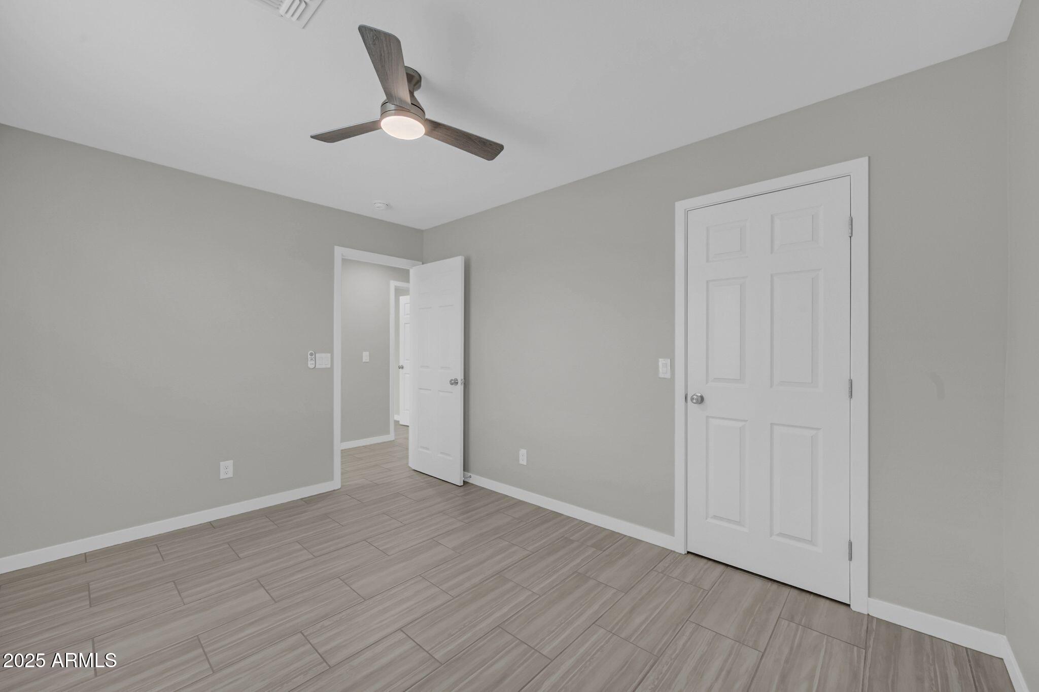 13215 South Laredo Road Arizona City, AZ 85123 - Photo 18 of 31 a view of an empty room and wooden floor