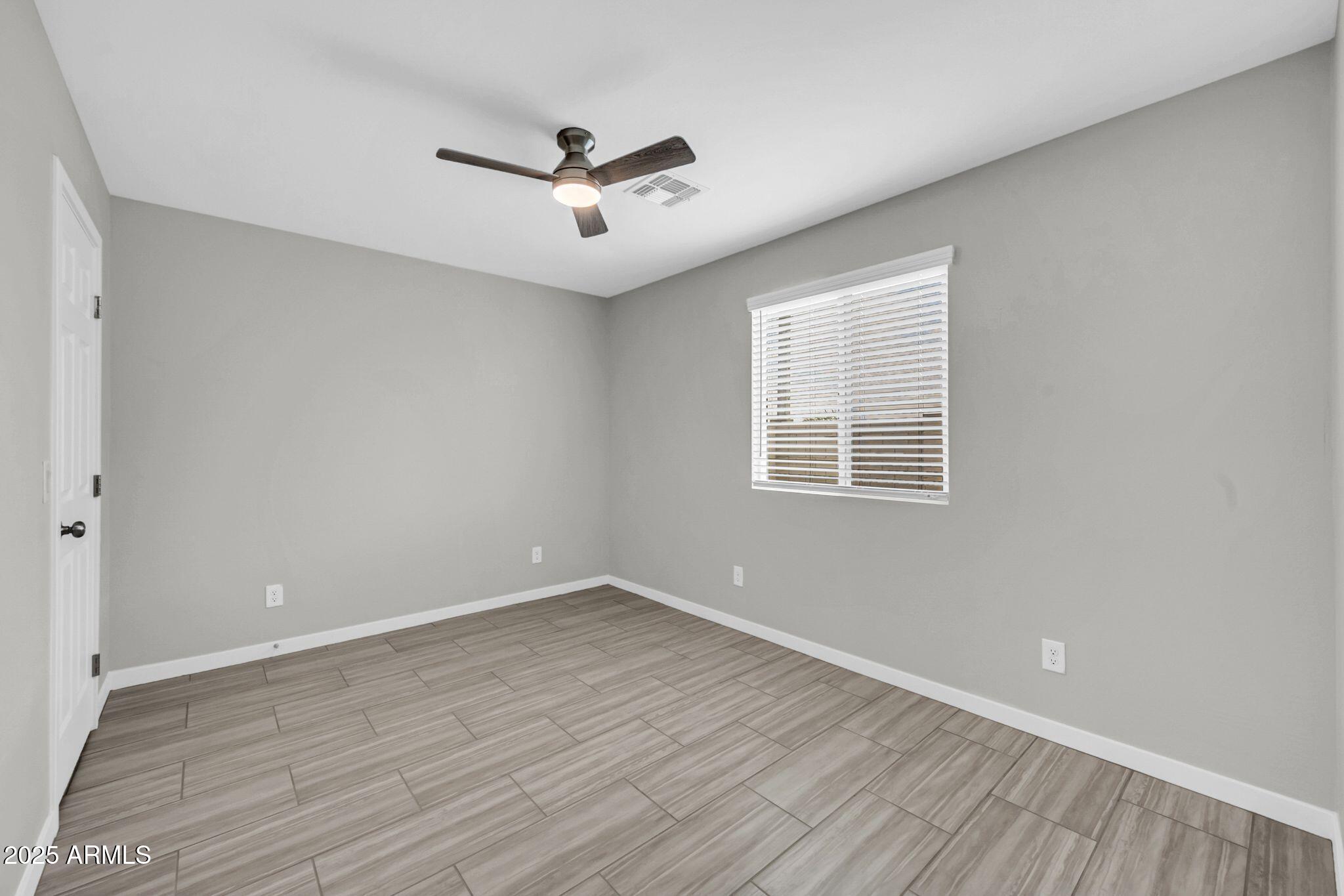 13215 South Laredo Road Arizona City, AZ 85123 - Photo 19 of 31 wooden floor in an empty room with a window